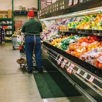 Employee stocks produce at Checkers grocery store